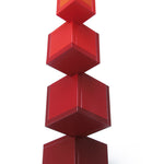 Naef's Cella cube toy twisted in a complex geometric pattern on a white background.