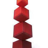 Naef's Cella cube toy twisted in a complex geometric pattern on a white background.