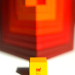 Naef Cella Cubes stacked corner to corner on top of each other on a white background.