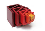 Naef Cella cube toy stacked in a twisting pyramid on a white background.
