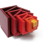 Naef Cella cube toy stacked in a twisting pyramid on a white background.
