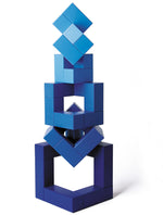 Blue Naef Cubicus stacked in a complex geometric tower on a white background.