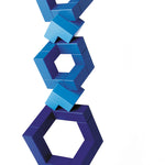 Blue Naef Cubicus stacked in a complex geometric tower on a white background.