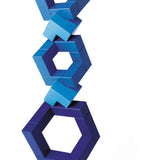 Blue Naef Cubicus stacked in a complex geometric tower on a white background.