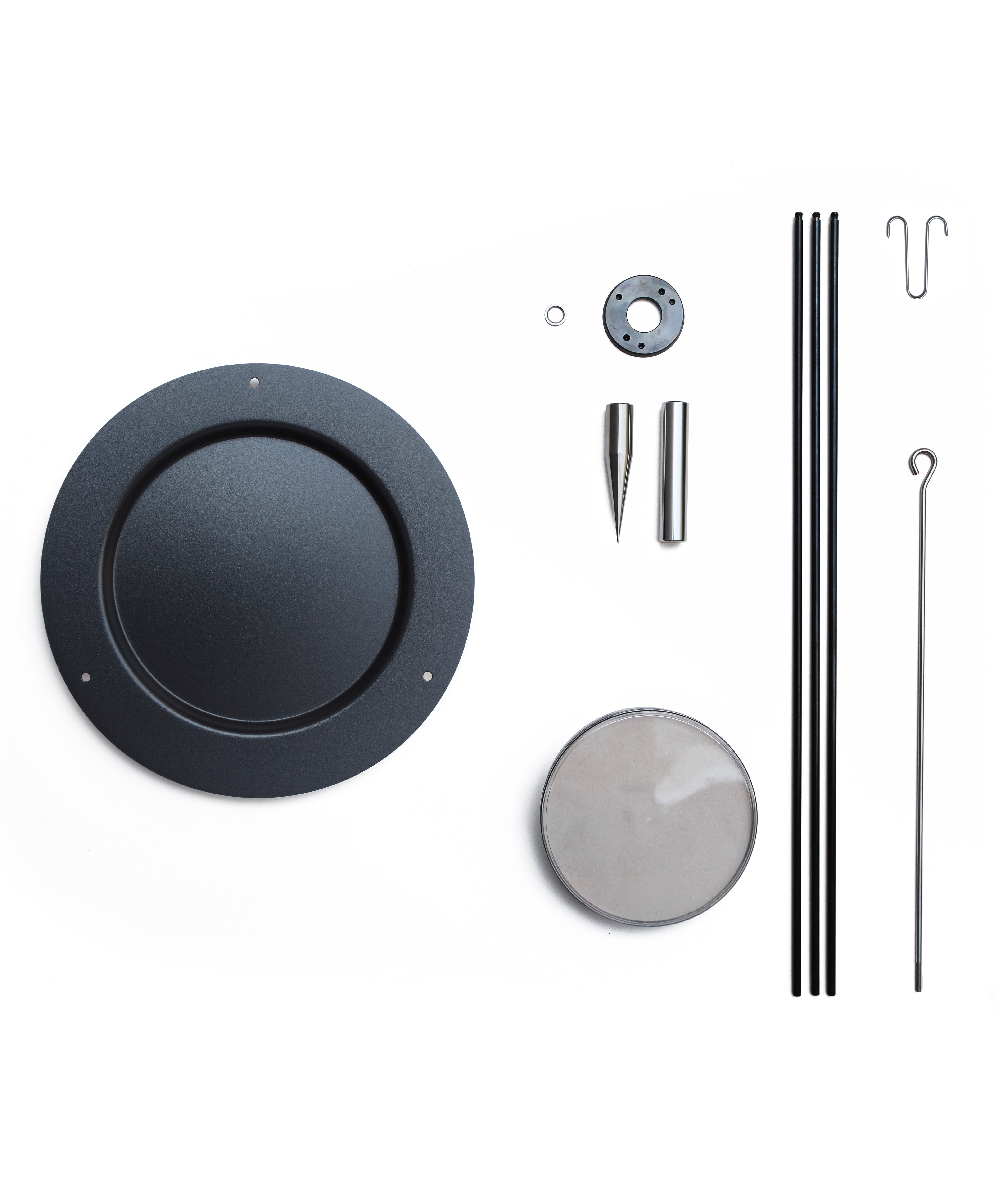 The individual parts of the Naef sand pendulum decorative physics toy, disassembled.
