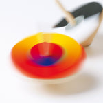 Naef premium bauhaus optical mixer coloured spinning tops rotating on a white background