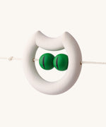 The Naef wooden pram toy in the shape of a cat, attached to a string.