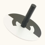 Naef handcrafted wooden spinning top in monochrome with a optical illusion