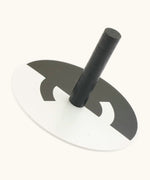 Naef handcrafted wooden spinning top in monochrome with a optical illusion