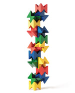 Naef Spiel wooden construction blocks stacked in a geometric tower on a white background