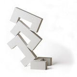 4 white Naef Quadrigo pieces stacked on one another to make a tower on a white background.