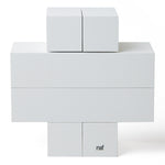 4 identical pieces of Naef's Quadrigo wooden toy slotted together to make a cross shape on a white background.