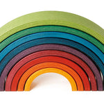 9 piece Naef wooden stacking rainbow on a white background.