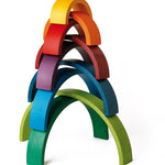 9 arches of Naef's wooden rainbow toy upturned in a half pipe shape