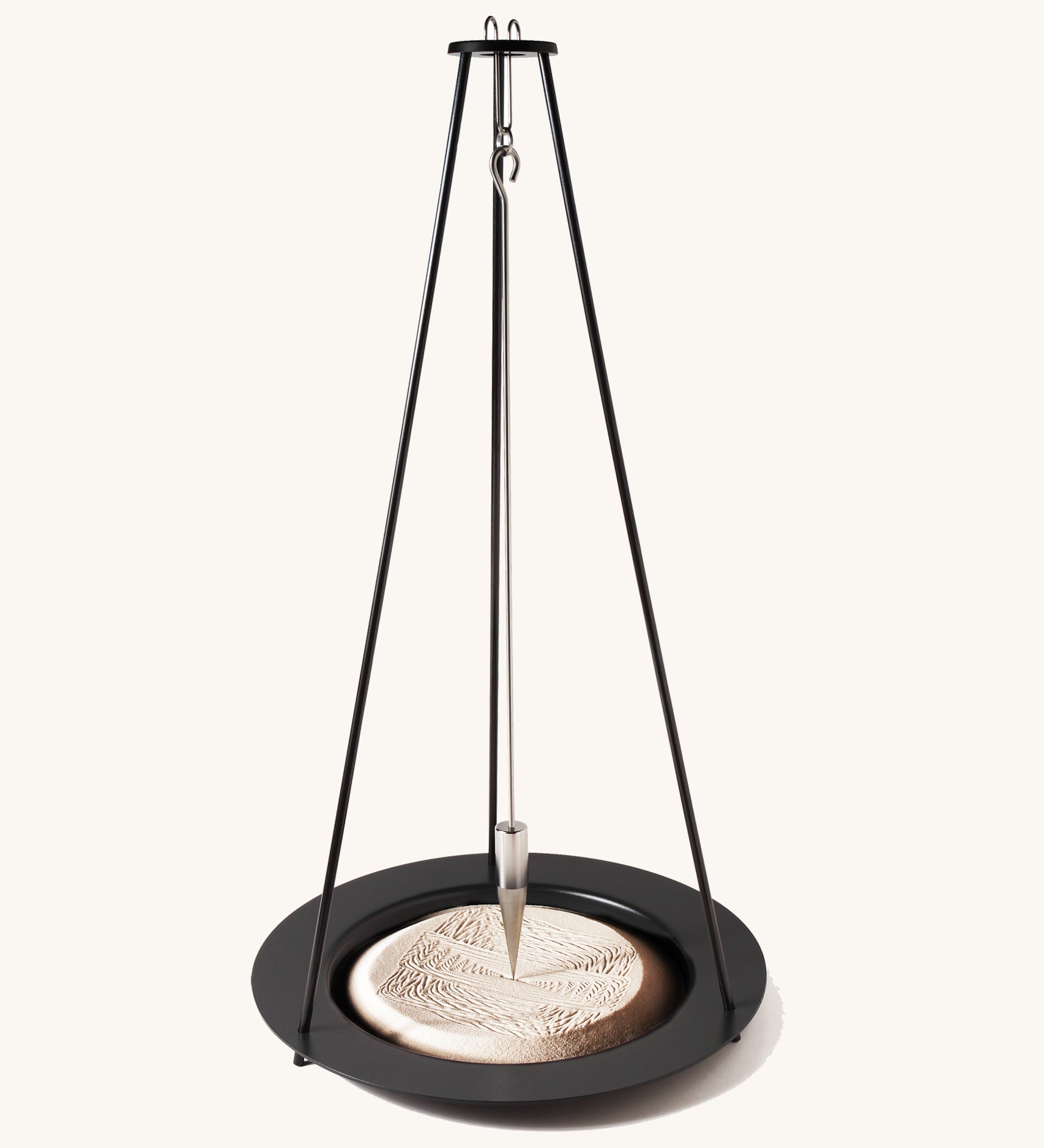 The Naef sand pendulum, a mathematical executive toy creating patterns in the sand.