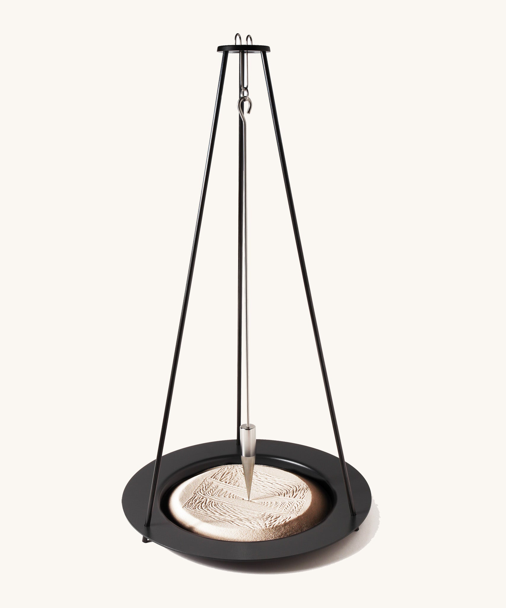 The Naef sand pendulum, a mathematical executive toy creating patterns in the sand.