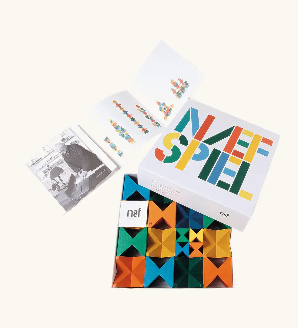 Naef spiel special 100 year edition spiel block set shown in their box with booklet. Tribute to Kurt Naef on the 100th anniversary of the founder's birth featuring a 60's inspired colour pallete. 