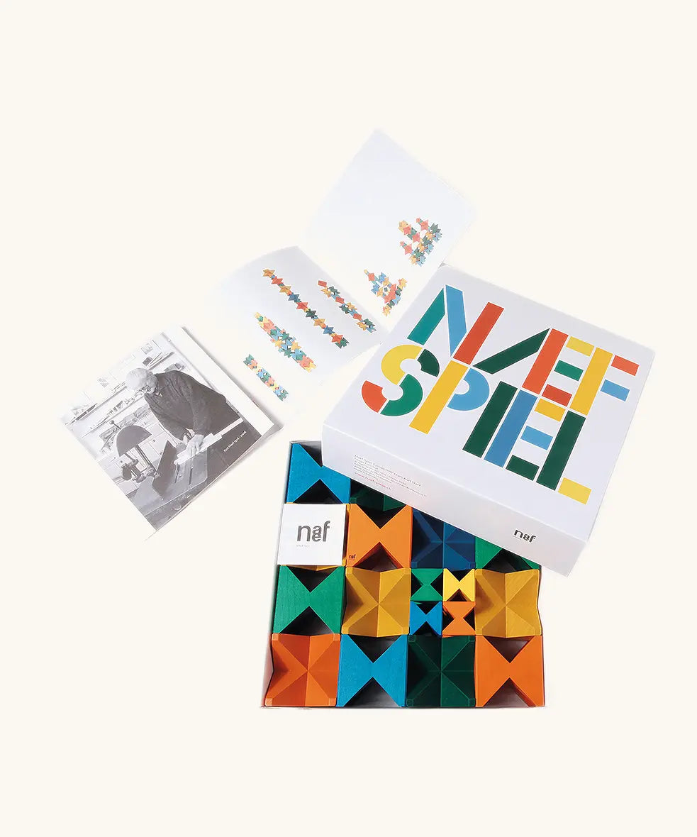 Naef spiel special 100 year edition spiel block set shown in their box with booklet. Tribute to Kurt Naef on the 100th anniversary of the founder's birth featuring a 60's inspired colour pallete. 