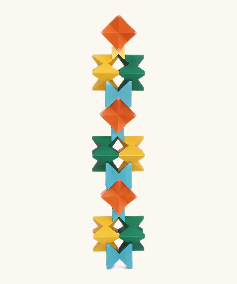 Naef spiel special 100 year edition spiel block set shown stacked into a tall tower. Tribute to Kurt Naef on the 100th anniversary of the founder's birth featuring a 60's inspired colour pallete. 
