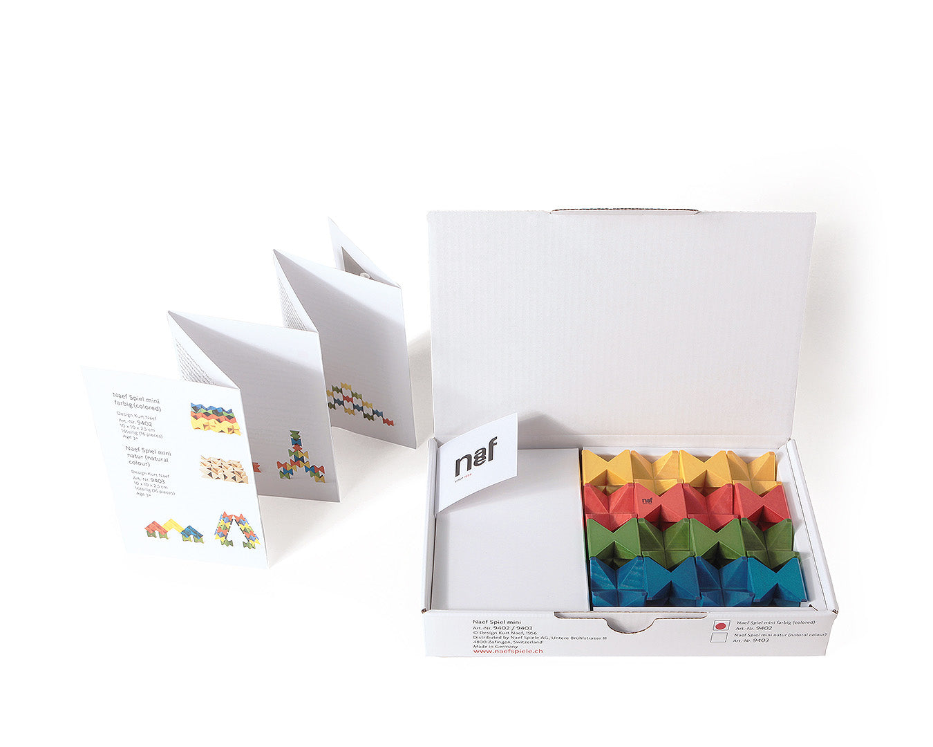 Open box of the Naef Spiel Mini precision wooden toy showing colourful interlocking cubes, booklet, and Naef logo. German made wooden puzzle and stacking game for adults and children.