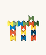 Colourful geometric structure built from Naef Spiel Mini precision wooden blocks in red, blue, yellow, and green. Modern German made wooden puzzle and desk toy.