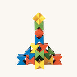 Complex vertical tower built with Naef Spiel Mini interlocking coloured blocks. German made wooden construction toy combining art, design, and precision play.