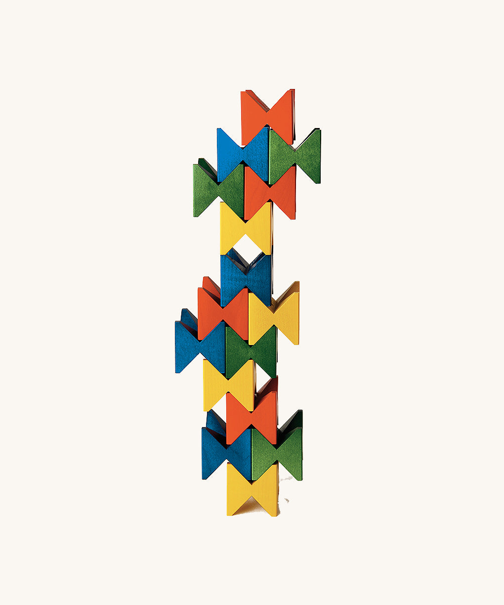 Vertical tower made from colourful Naef Spiel Mini interlocking wooden cubes. Premium German made desk toy and geometric wooden puzzle.