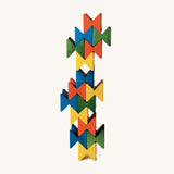 Vertical tower made from colourful Naef Spiel Mini interlocking wooden cubes. Premium German made desk toy and geometric wooden puzzle.