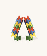 Naef Spiel Mini construction in bright primary colours forming an arch shape. High quality precision wooden stacking game handcrafted in Germany.