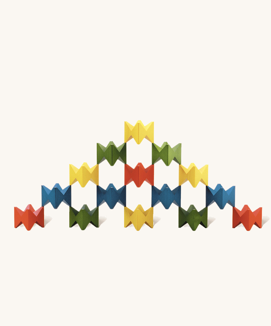 Pyramid-like creation built with Naef Spiel Mini precision wooden blocks in red, blue, green, and yellow. Elegant German made stacking game and design object.
