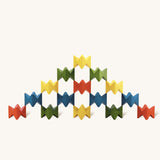 Pyramid-like creation built with Naef Spiel Mini precision wooden blocks in red, blue, green, and yellow. Elegant German made stacking game and design object.
