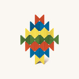 Colourful geometric structure built from Naef Spiel Mini precision wooden blocks in red, blue, yellow, and green. Modern German made wooden puzzle and desk toy.