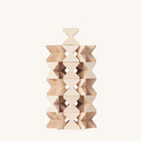 The Naef Mini Spiel in natural, made in Germany and designed in Switzerland, stacked in a complex tower