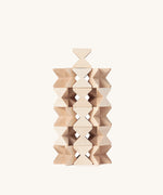 The Naef Mini Spiel in natural, made in Germany and designed in Switzerland, stacked in a complex tower