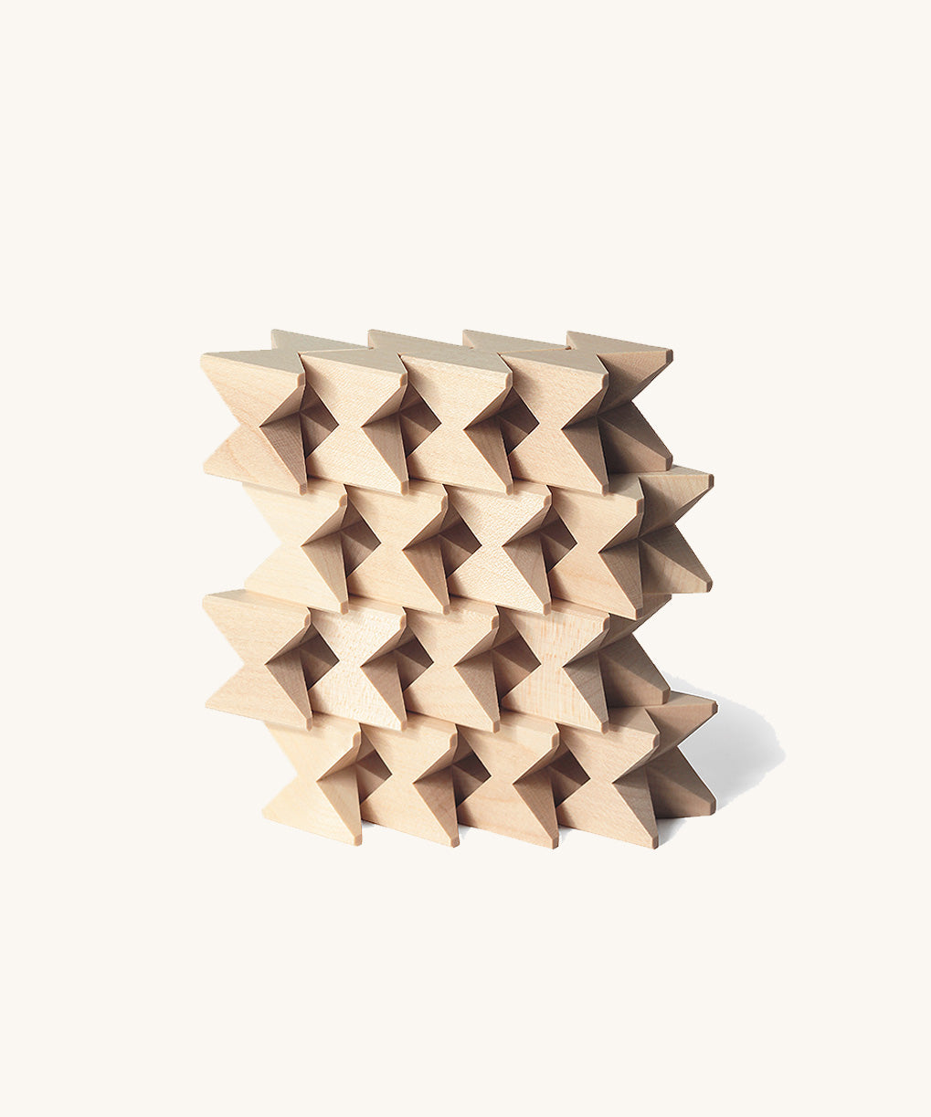 Naef Spiel mini in natural, wooden cubes stacked in a compact wall.