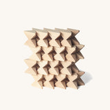 Naef Spiel mini in natural, wooden cubes stacked in a compact wall.