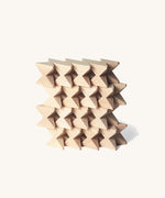 Naef Spiel mini in natural, wooden cubes stacked in a compact wall.