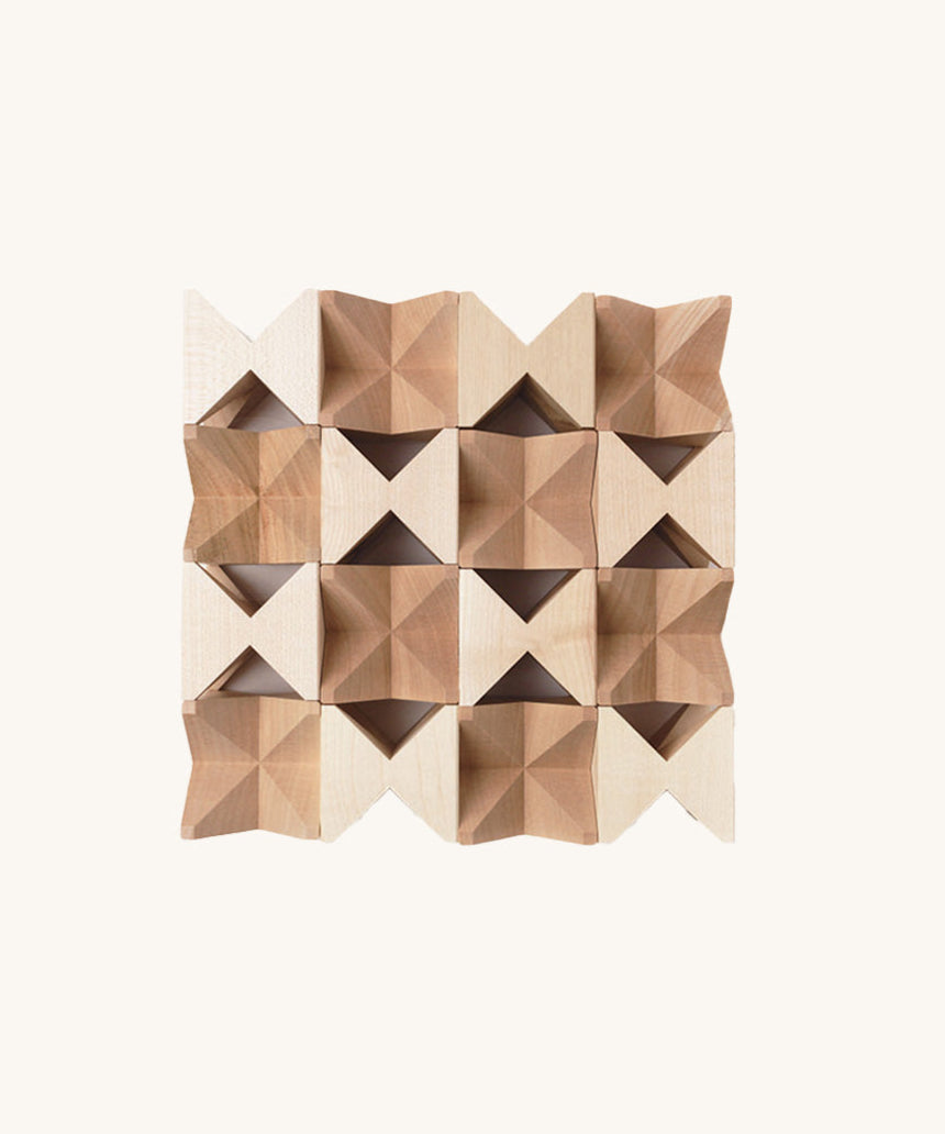 The Naef Spiel Mini in natural, laid out in a square formation and highlighting the natural grain of the hand cut maple wood. 