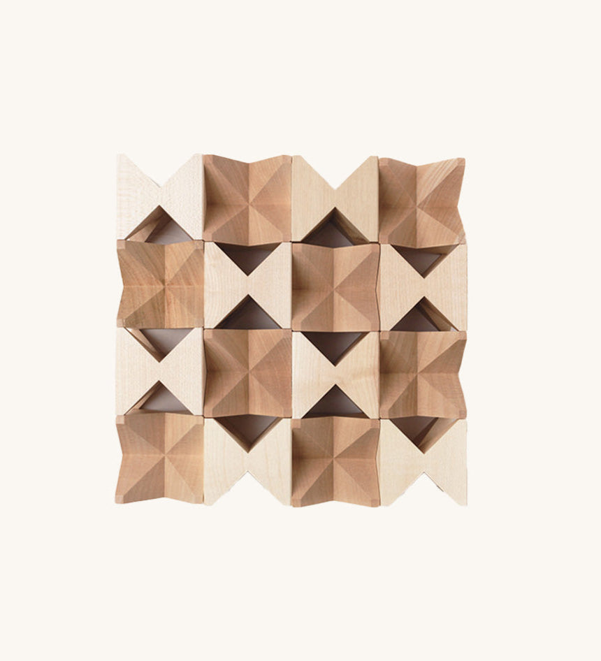 The Naef Spiel Mini in natural, laid out in a square formation and highlighting the natural grain of the hand cut maple wood. 
