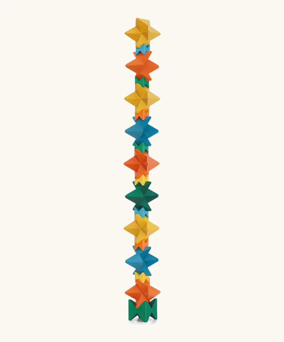 Naef spiel special 100 year edition spiel block set shown stacked into a tall tower. Tribute to Kurt Naef on the 100th anniversary of the founder's birth featuring a 60's inspired colour pallete. 