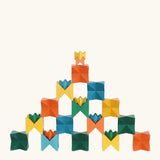 Naef spiel special 100 year edition spiel block set shown stacked into a pyramid like tower structure. Tribute to Kurt Naef on the 100th anniversary of the founder's birth featuring a 60's inspired colour pallete. 