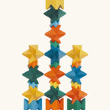 Naef spiel special 100 year edition spiel block set shown stacked into a tower. Tribute to Kurt Naef on the 100th anniversary of the founder's birth featuring a 60's inspired colour pallete. 