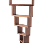 The Naef Corus wooden walnut stacking blocks, stacked high with the smallest piece on the bottom of the stack, and the largest piece balancing on the top. 