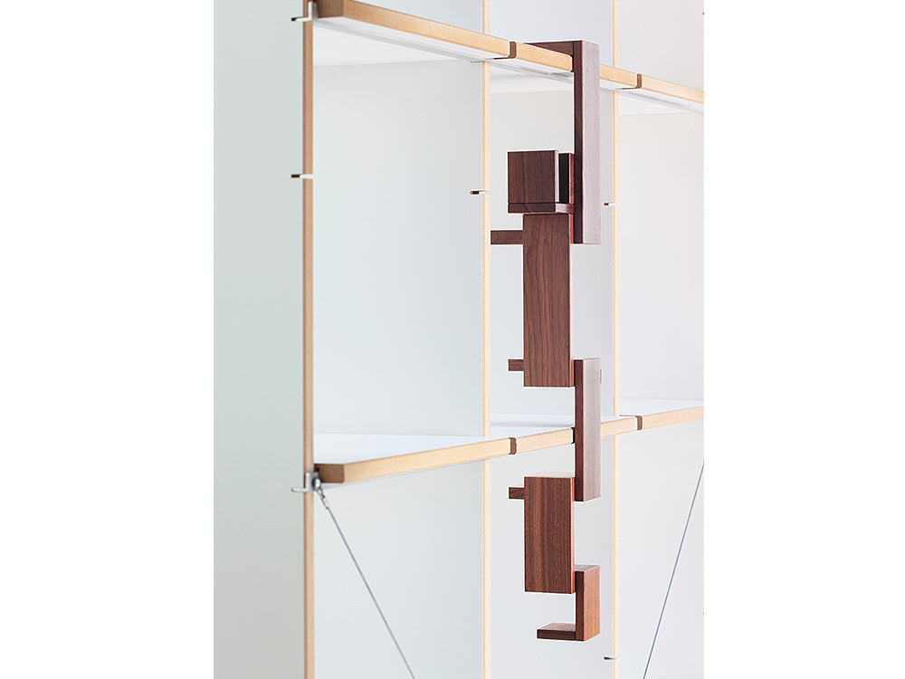 The Naef Walnut Corus, hanging from a shelf to create an interesting sculpture.