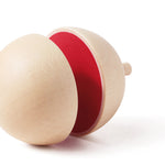 Naef spinning top on its side showing the red interior colouring on a white background