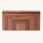 The Naef Corus wooden stacking toy, with all seven pieces neatly stacked on top of each other to form a cuboid.