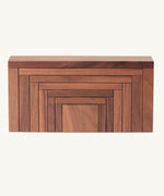 The Naef Corus wooden stacking toy, with all seven pieces neatly stacked on top of each other to form a cuboid.