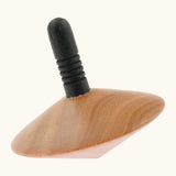 Naef handcrafted wooden spinning top showing a black stem with grooves for grip 
