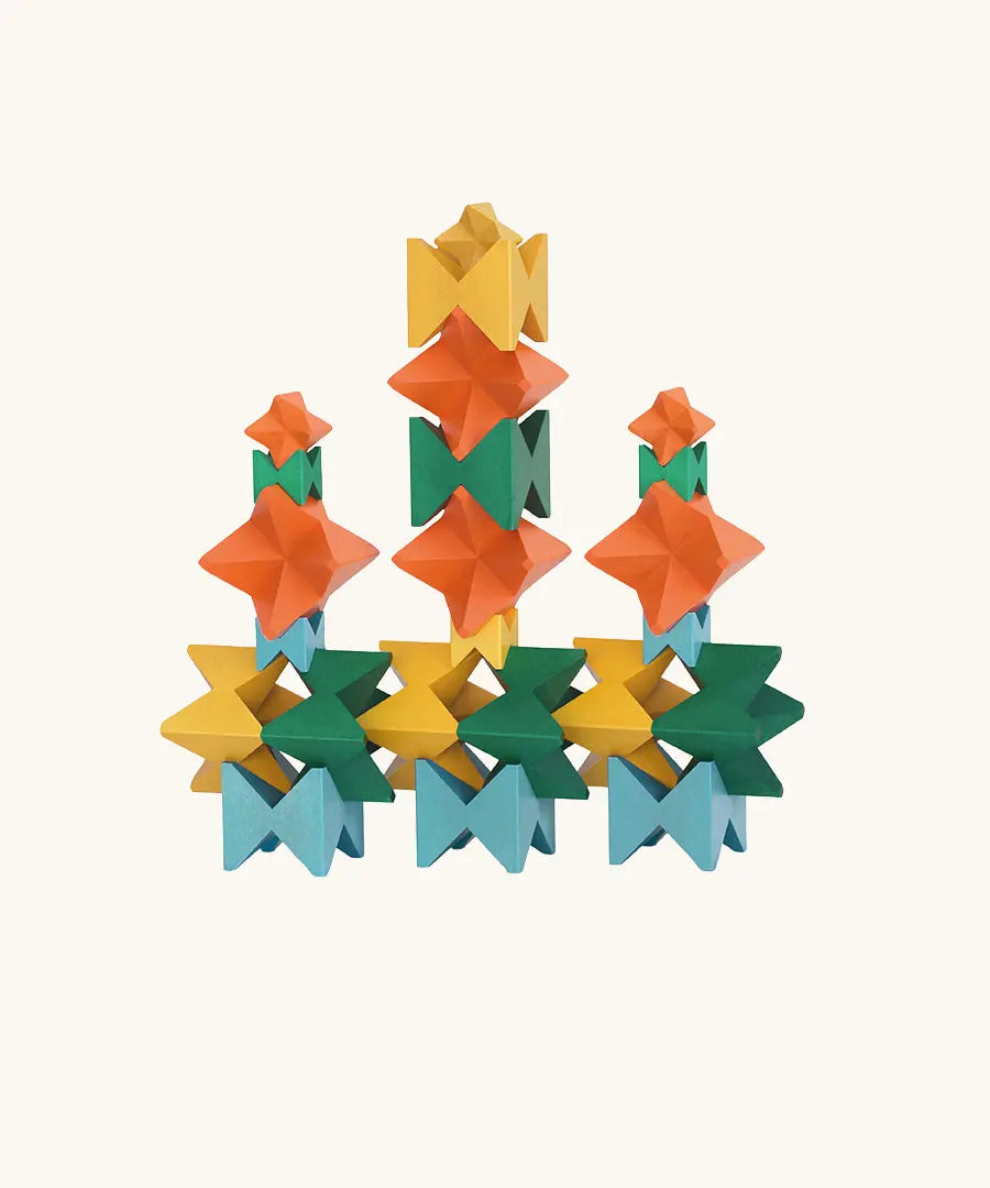 Naef Spiel signature stamped edition cubes stacked up to form three towers on a long base.