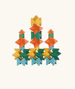 Naef Spiel signature stamped edition cubes stacked up to form three towers on a long base.